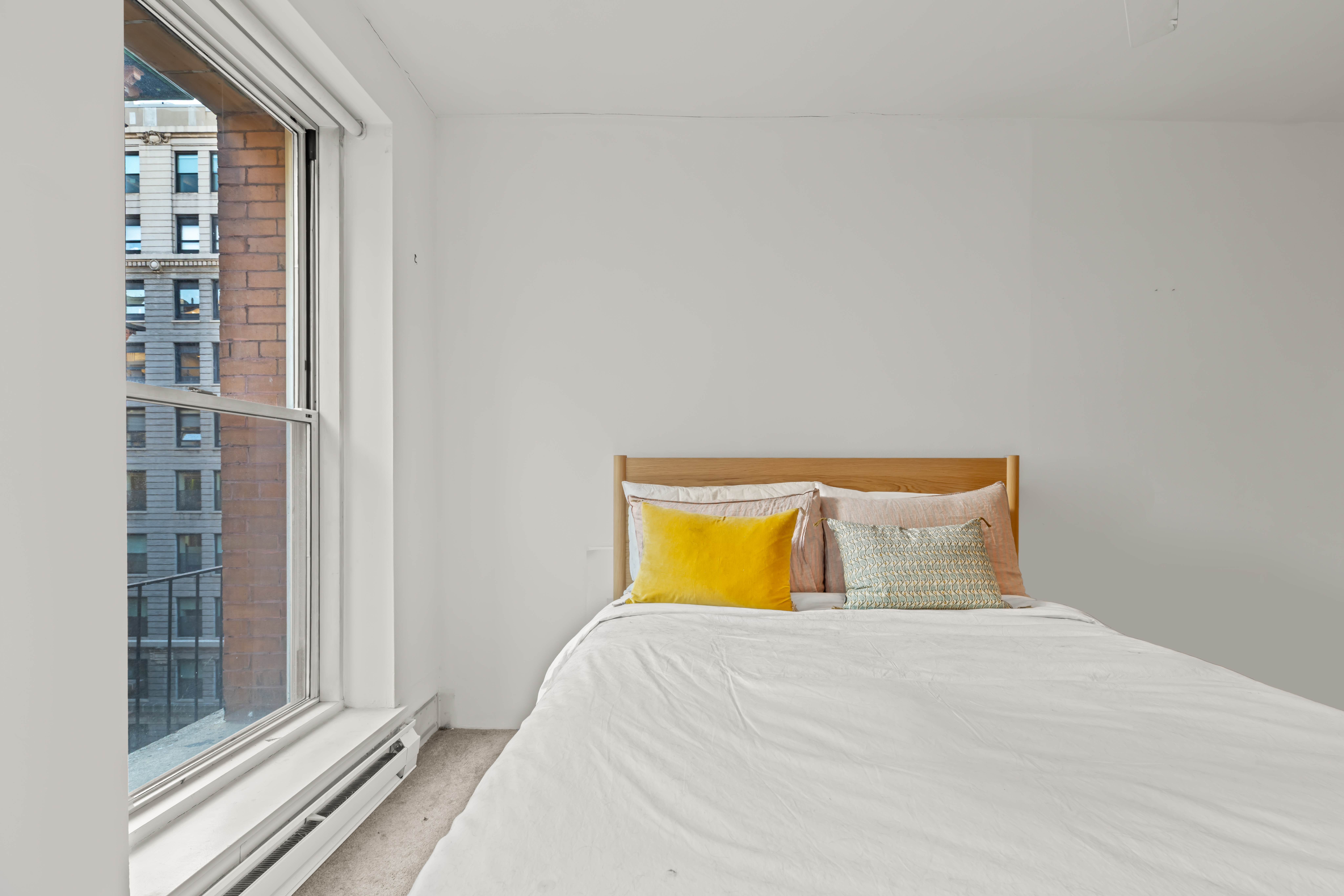 23 Waverly Place, Unit 6M Manhattan, NY 10003 - Photo 6 of 22 a bedroom with a bed and a window