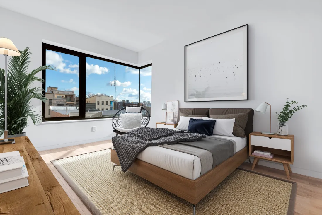 a bedroom with a large bed and a large window