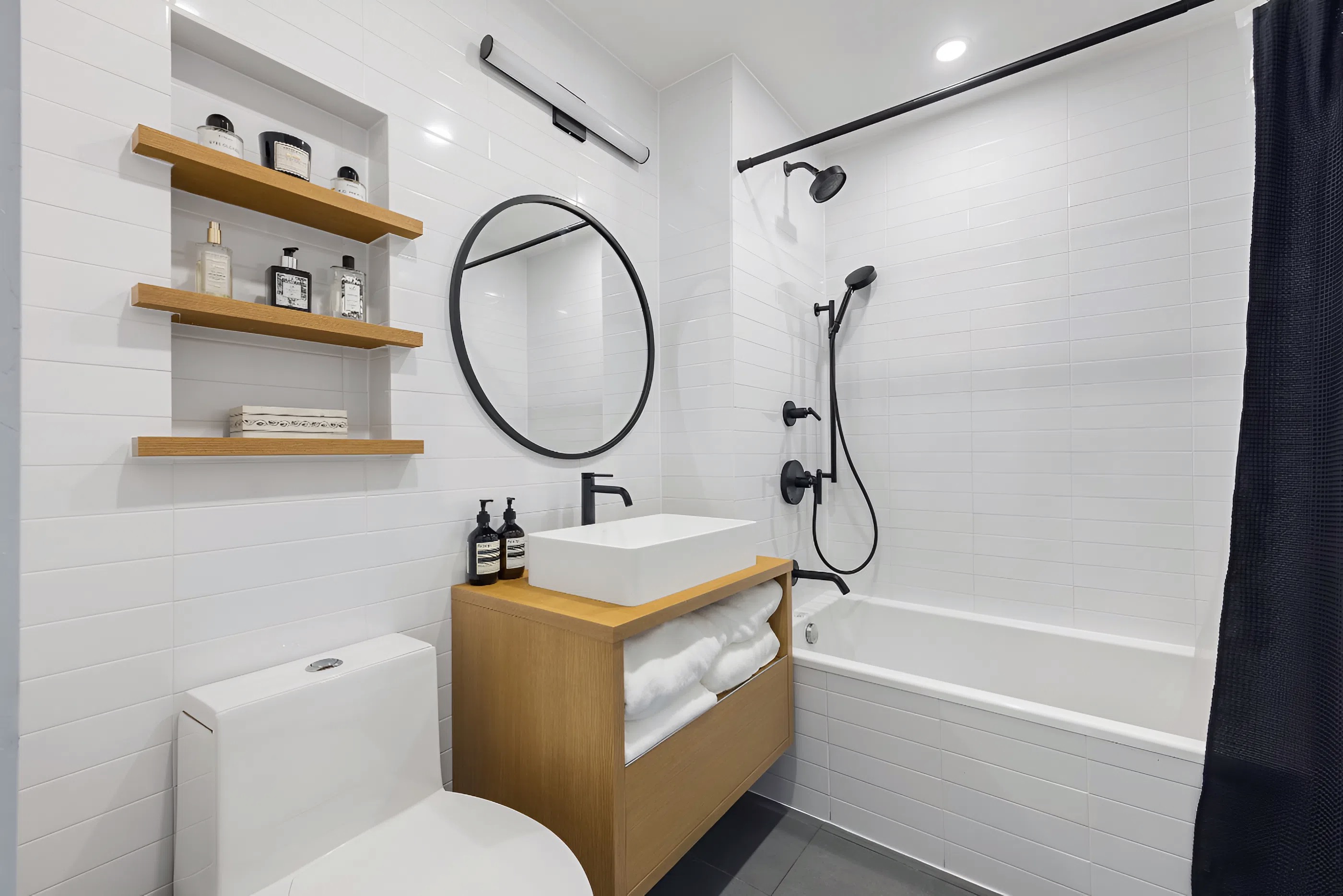 340 Metropolitan Avenue, Unit PHB Brooklyn, NY 11211 - Photo 11 of 18 a bathroom with a sink a toilet and a mirror