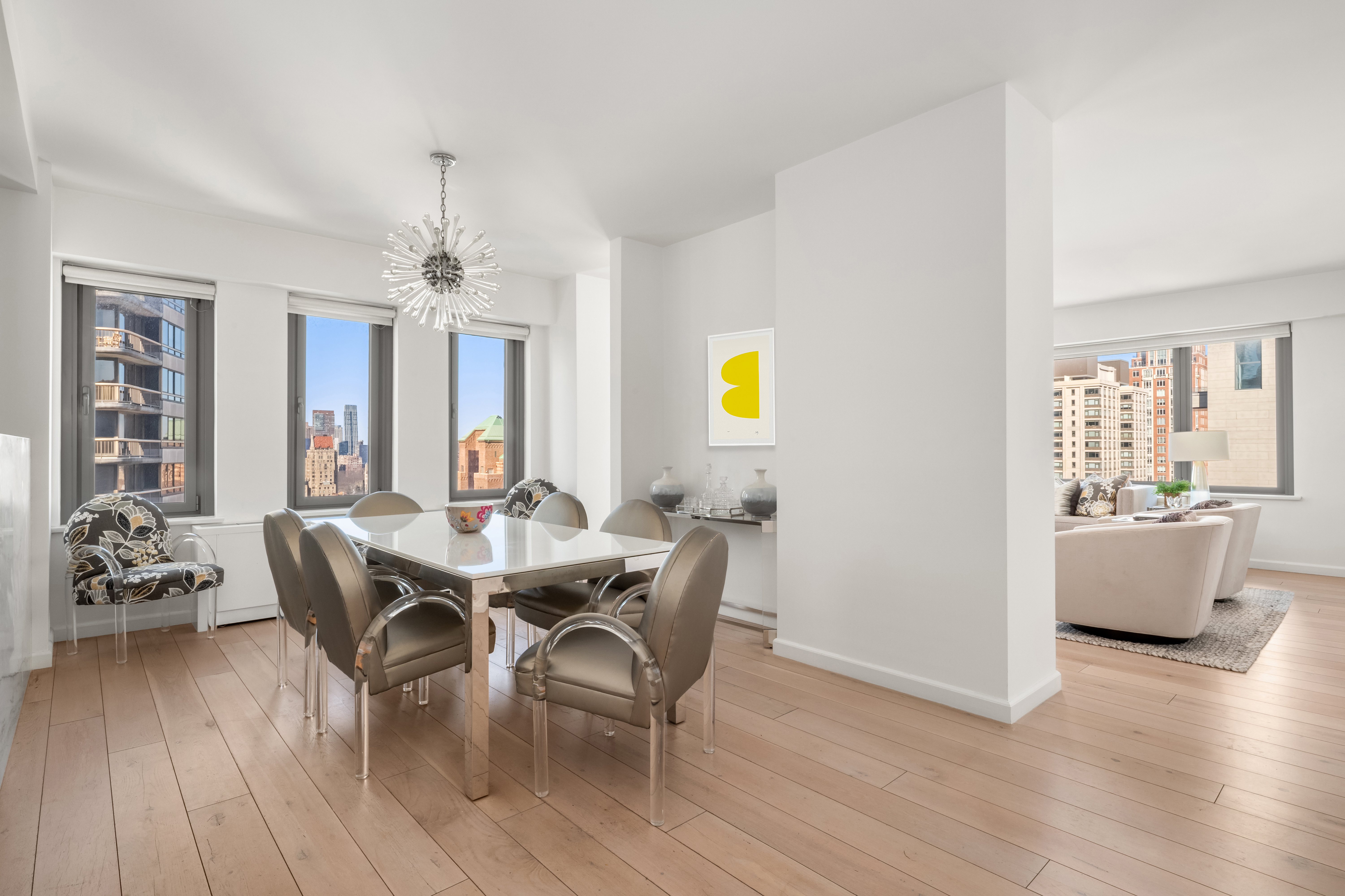 200 East 62nd Street, Unit 27A Manhattan, NY 10065 - Photo 3 of 19 a view of a dining room with furniture and wooden floor