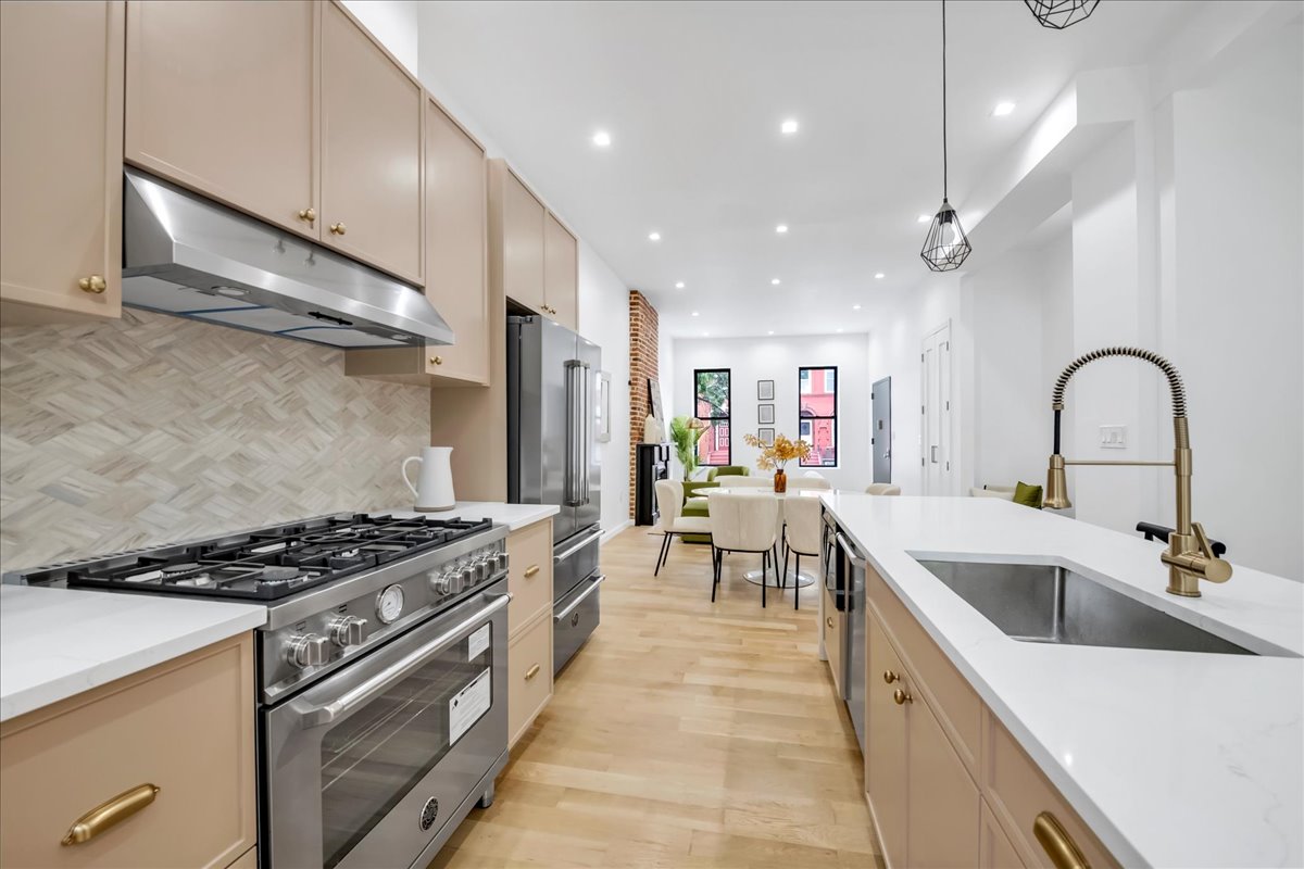 448 Halsey Street, Unit 1 Brooklyn, NY 11233 - Photo 10 of 22 a kitchen with stainless steel appliances granite countertop a sink and cabinets