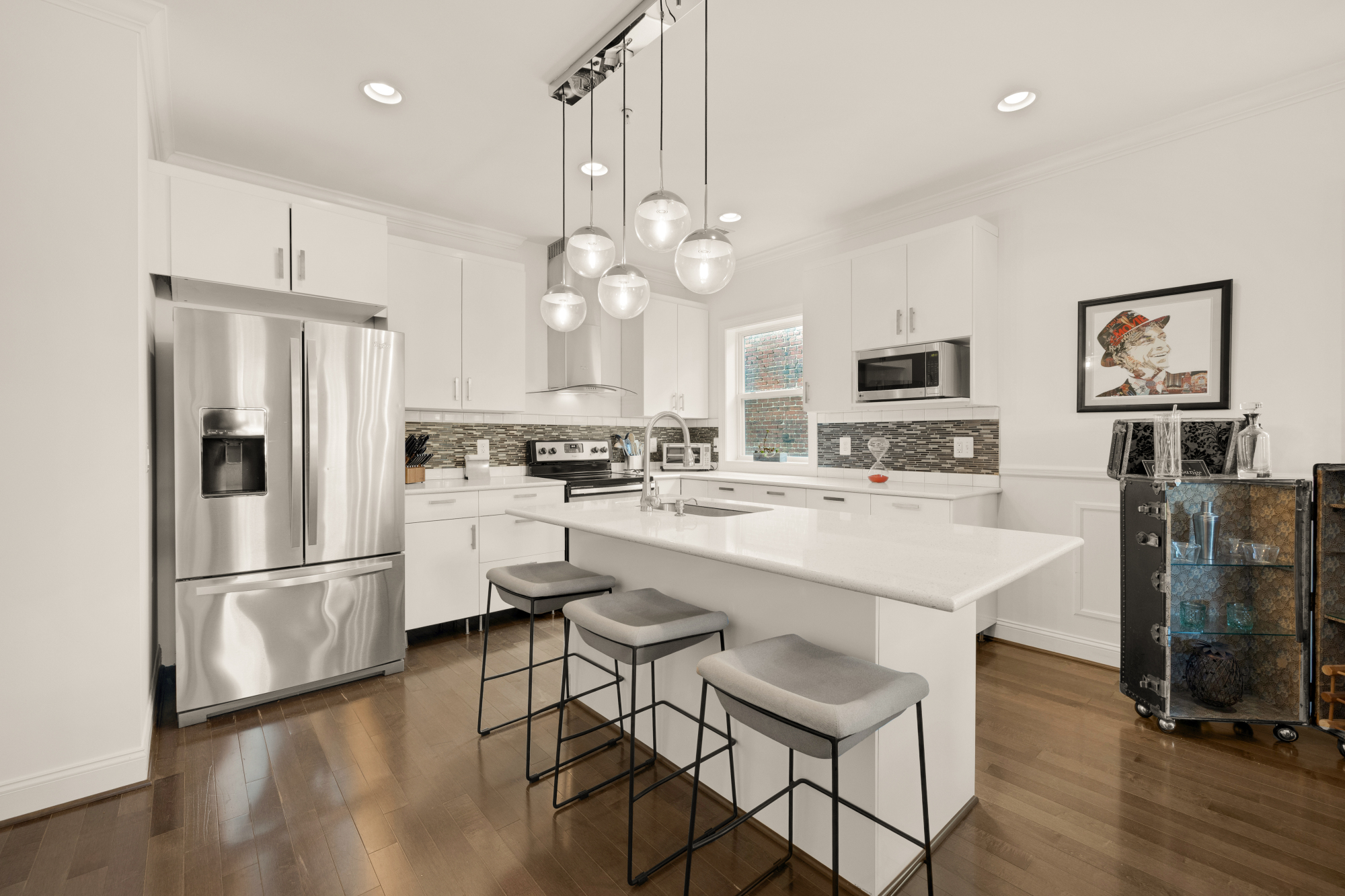 233 S Street Northeast, Unit 4 Washington, DC 20002 - Photo 11 of 37 a kitchen with kitchen island white cabinets and stainless steel appliances