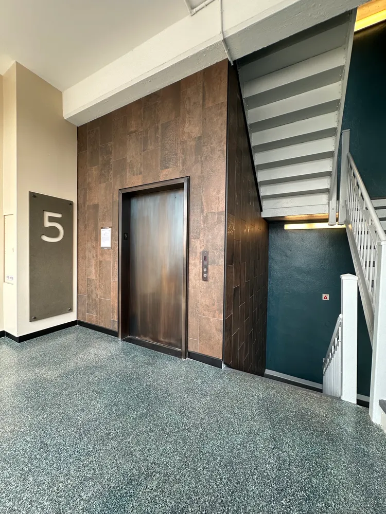 an empty room with closet and windows