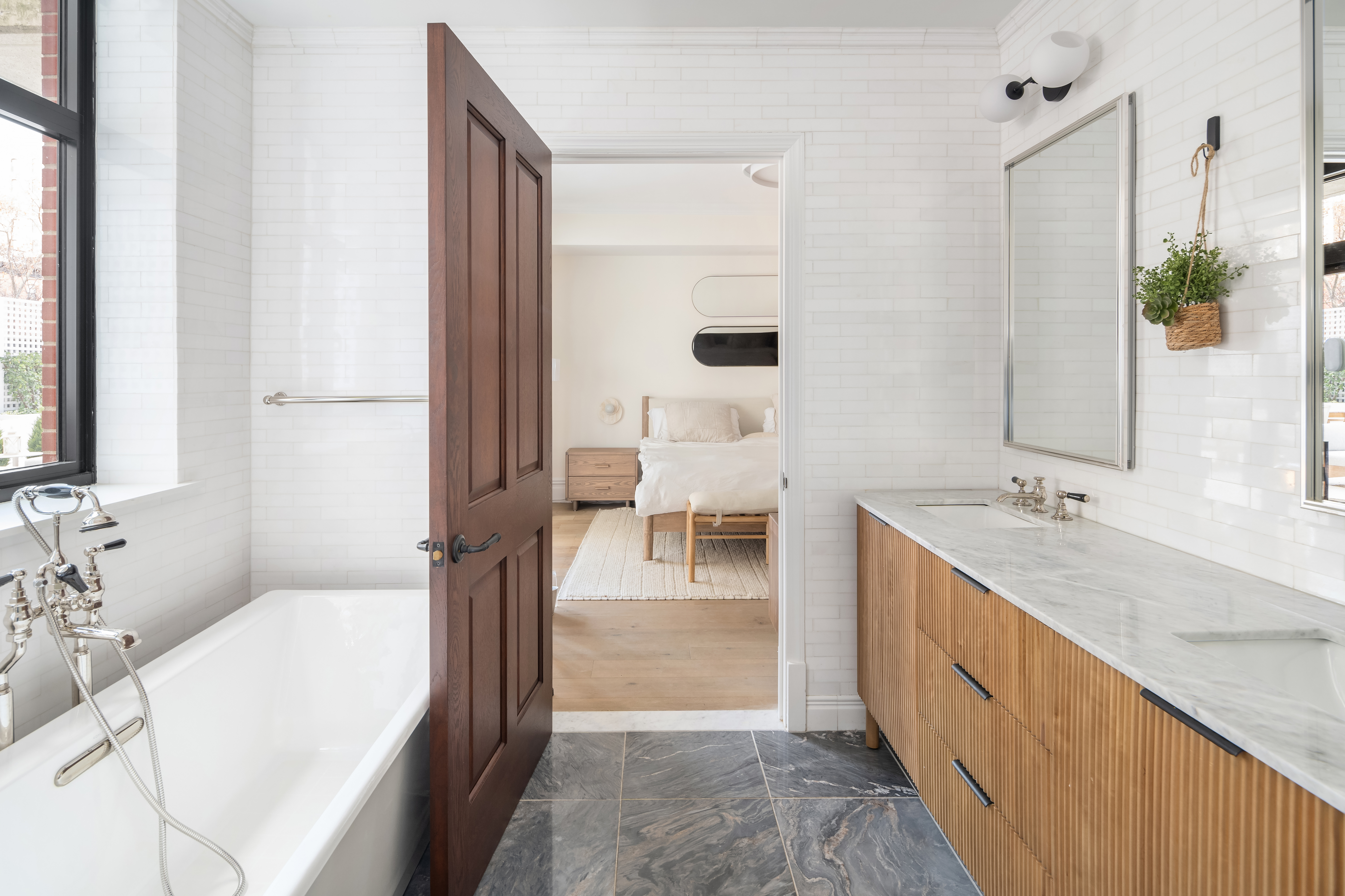 199 Mott Street, Unit 2 Manhattan, NY 10012 - Photo 12 of 14 a bathroom with a double vanity sink and mirror
