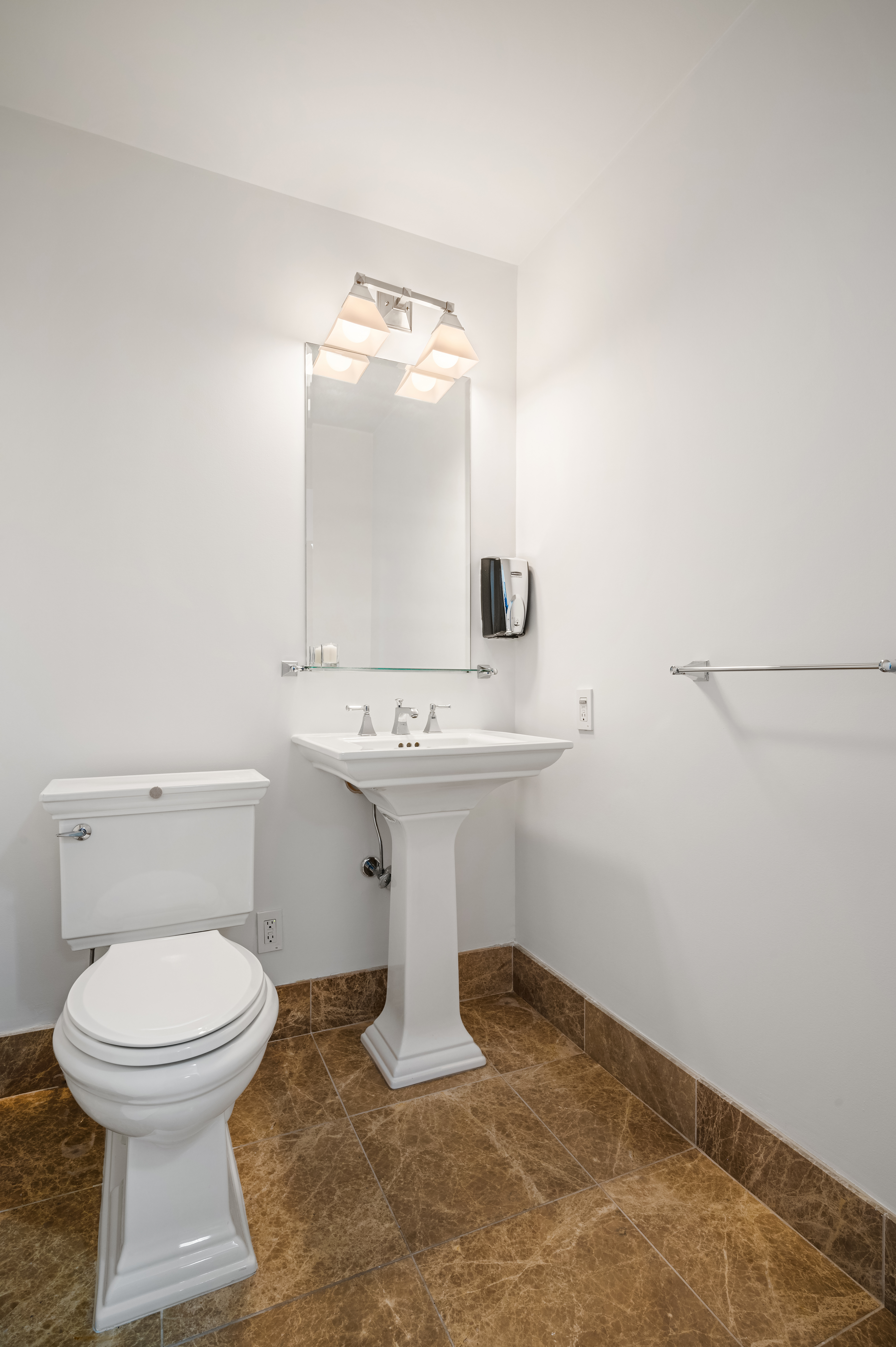 45 Park Avenue, Unit 1801 Manhattan, NY 10016 - Photo 9 of 12 a bathroom with a sink toilet and mirror