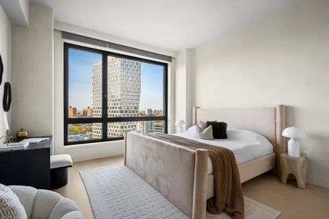 a bedroom with a large bed and a large window