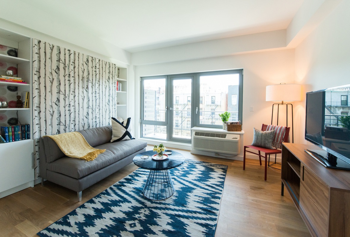 500 Sterling Place, Unit 3H Brooklyn, NY 11238 - Photo 1 of 12 a living room with furniture wooden floor and a flat screen tv