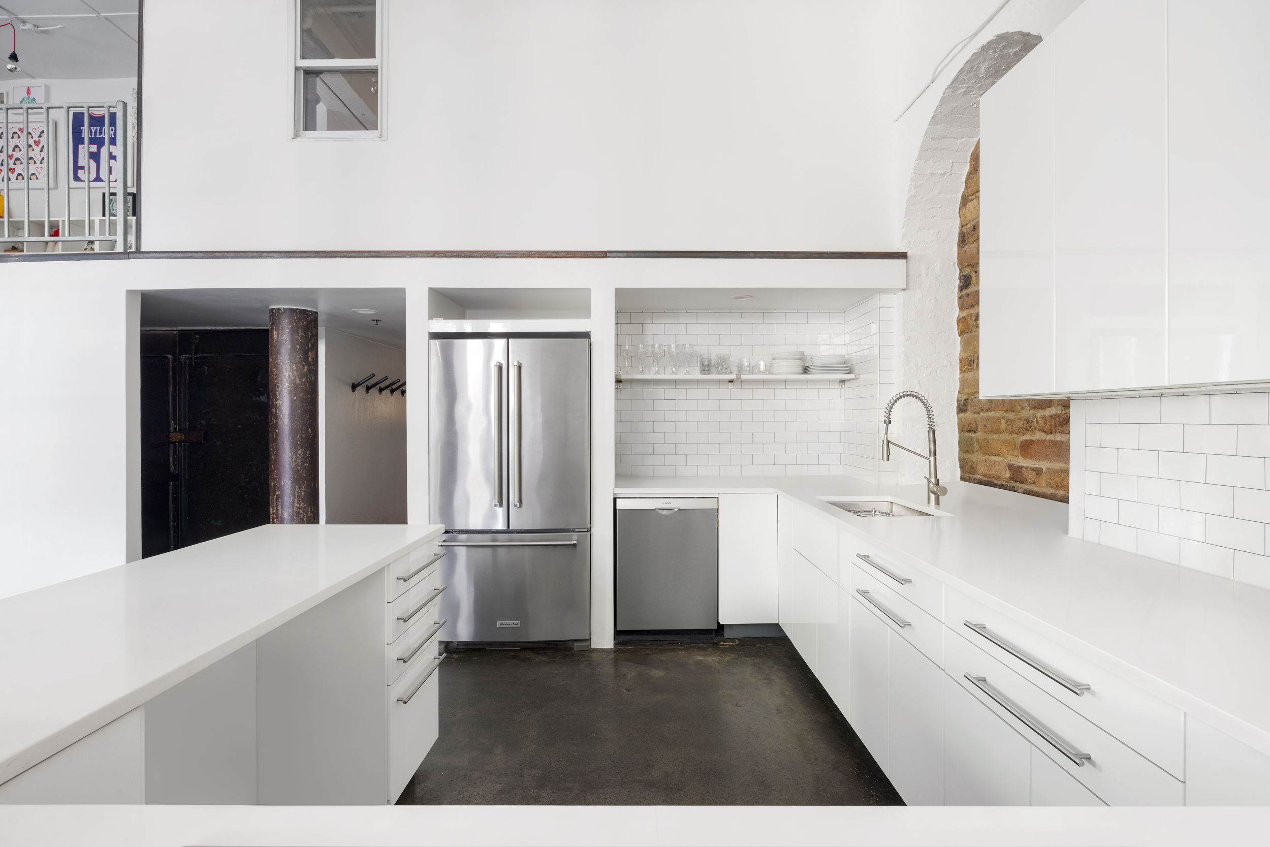 125 Watts Street, Unit 1 Manhattan, NY 10013 - Photo 8 of 24 a kitchen with a refrigerator and white cabinets