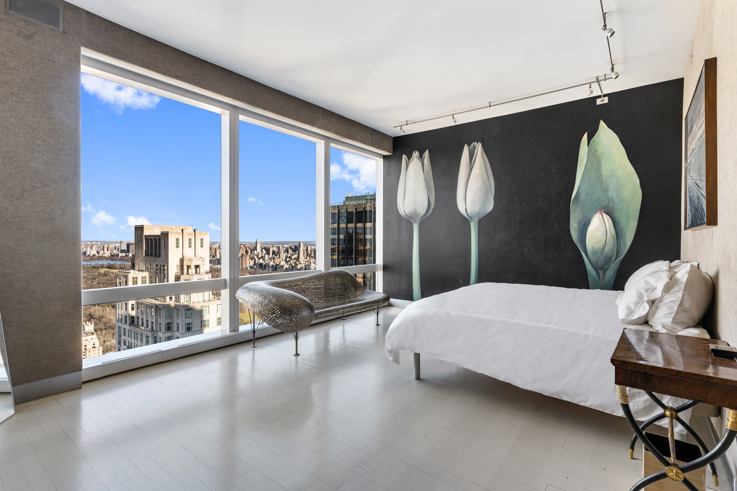 80 Columbus Circle, Unit 67B Manhattan, NY 10019 - Photo 5 of 16 a bedroom with a large bed and a large window