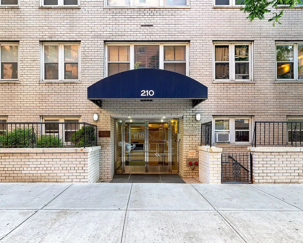 210 East 63rd Street, Unit 11F Manhattan, NY 10065 - Photo 10 of 14 a front view of a house with a garage
