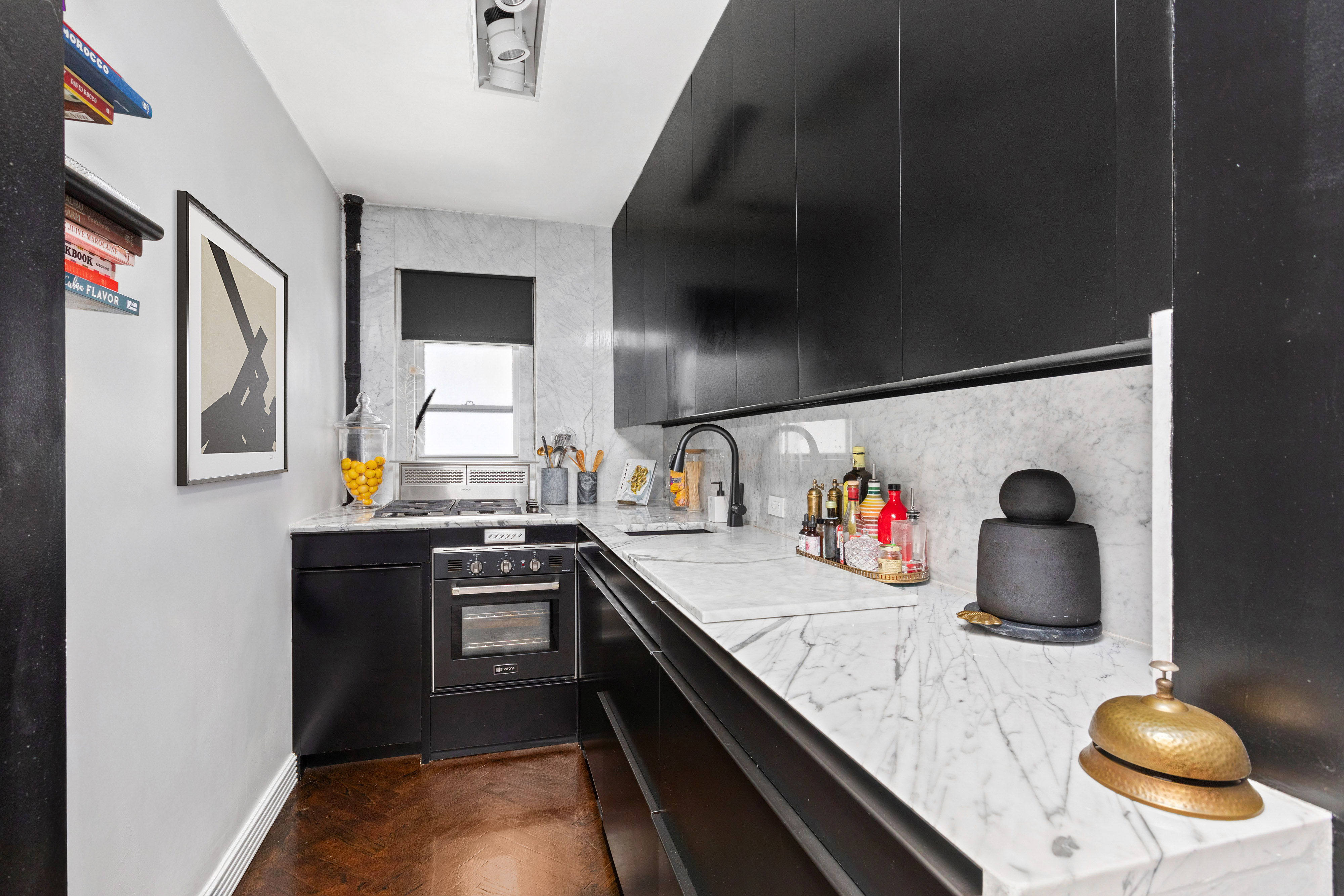135 East 39th Street, Unit 6D Manhattan, NY 10016 - Photo 7 of 11 a kitchen with stainless steel appliances granite countertop a sink and cabinets