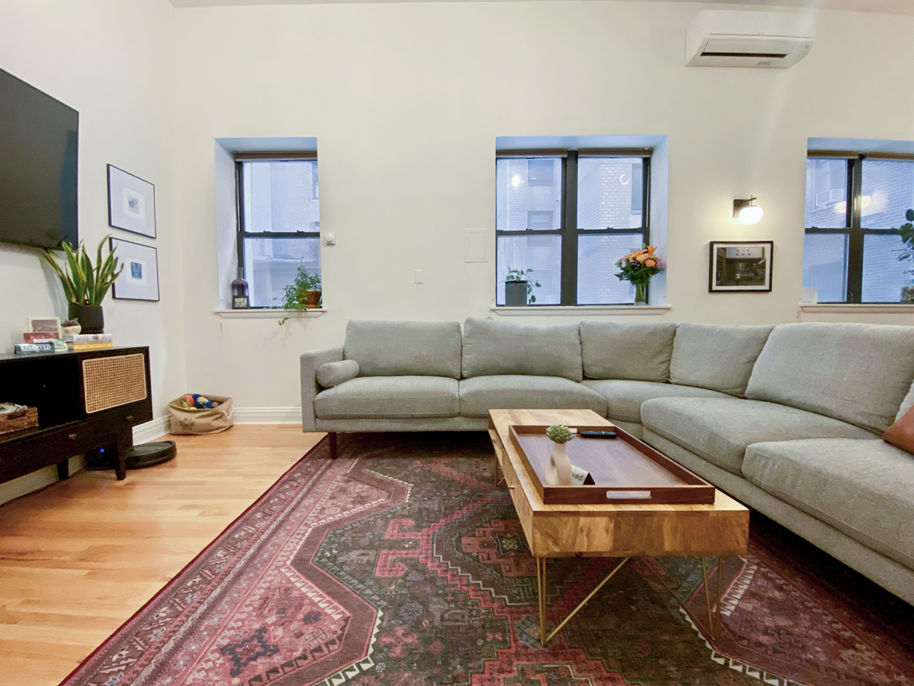 60 Court Street, Unit 2L Brooklyn, NY 11201 - Photo 2 of 9 a living room with furniture a rug and a flat screen tv