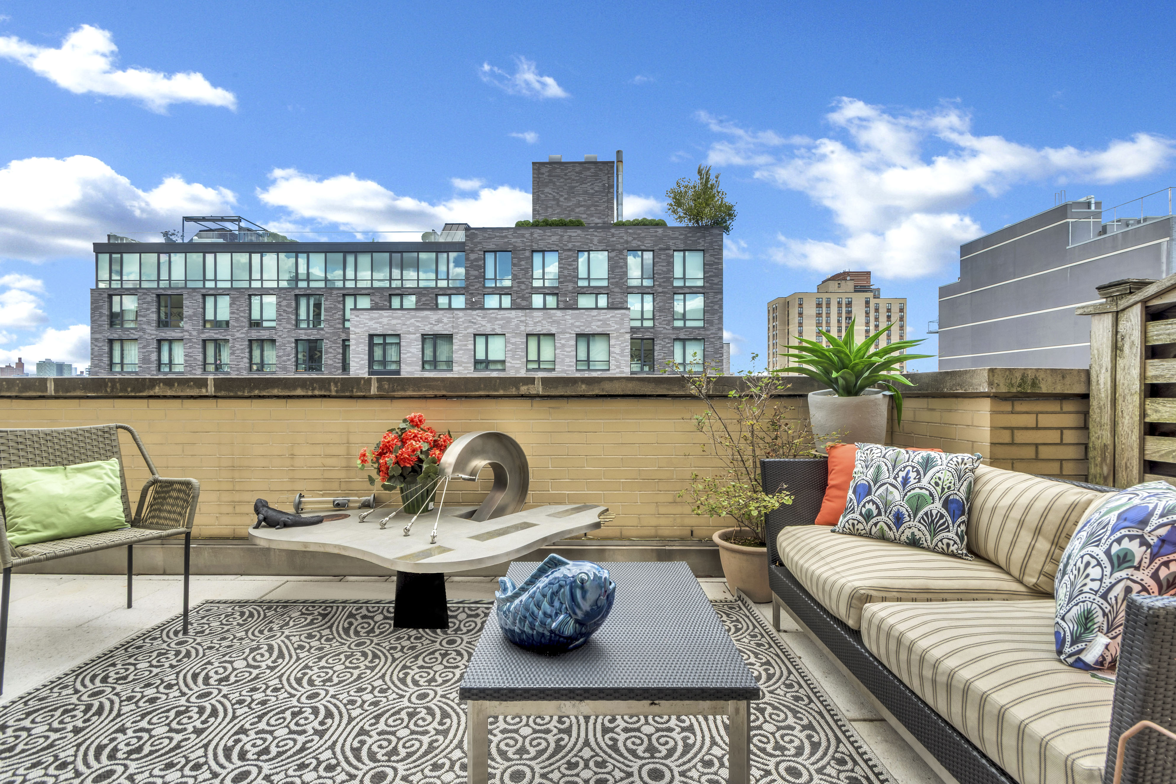 40 West 116th Street, Unit A907 Manhattan, NY 10026 - Photo 13 of 34 a living room with furniture and a potted plant