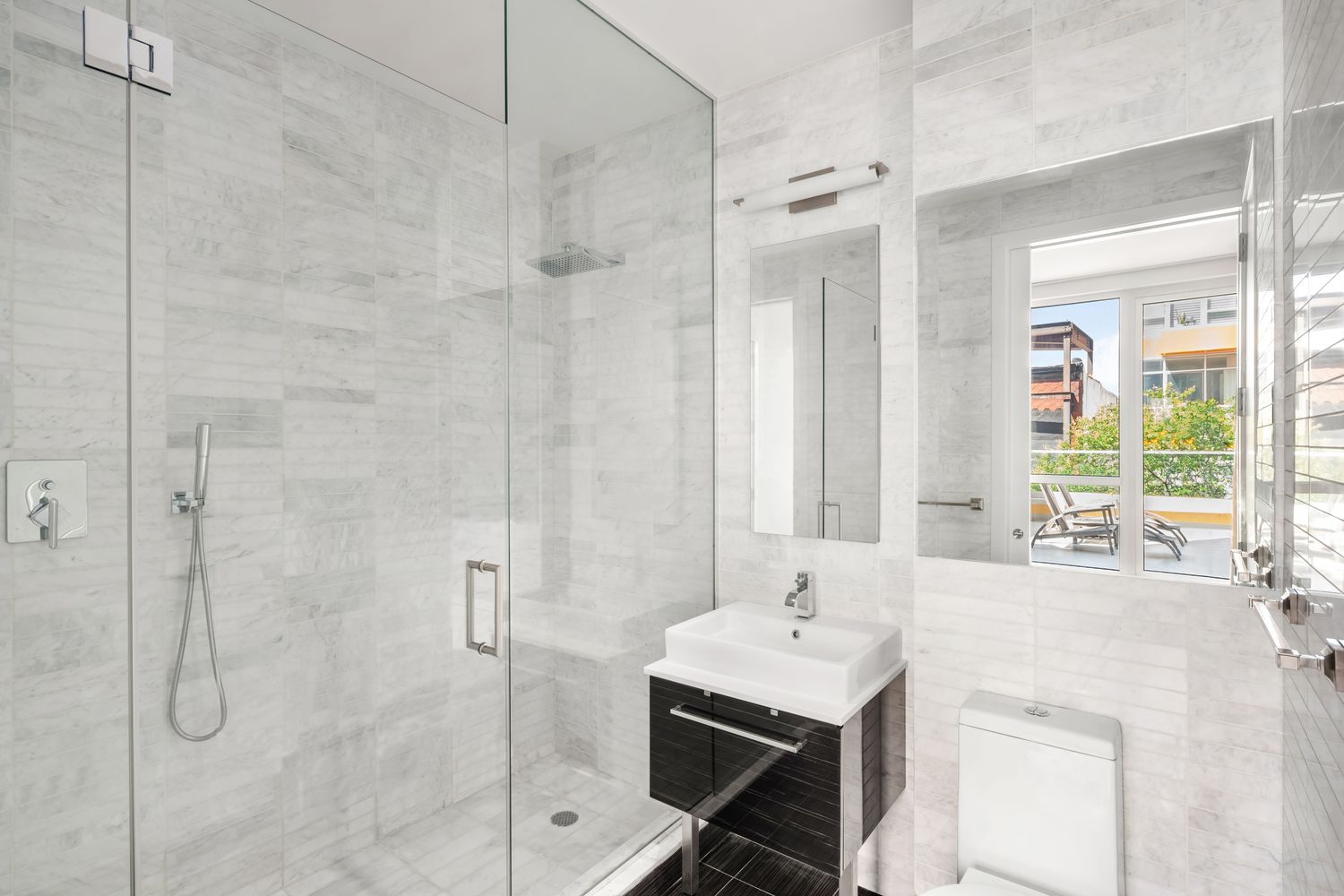 135 North 11th Street, Unit 2F Brooklyn, NY 11249 - Photo 4 of 10 a bathroom with a granite countertop sink and a bathtub