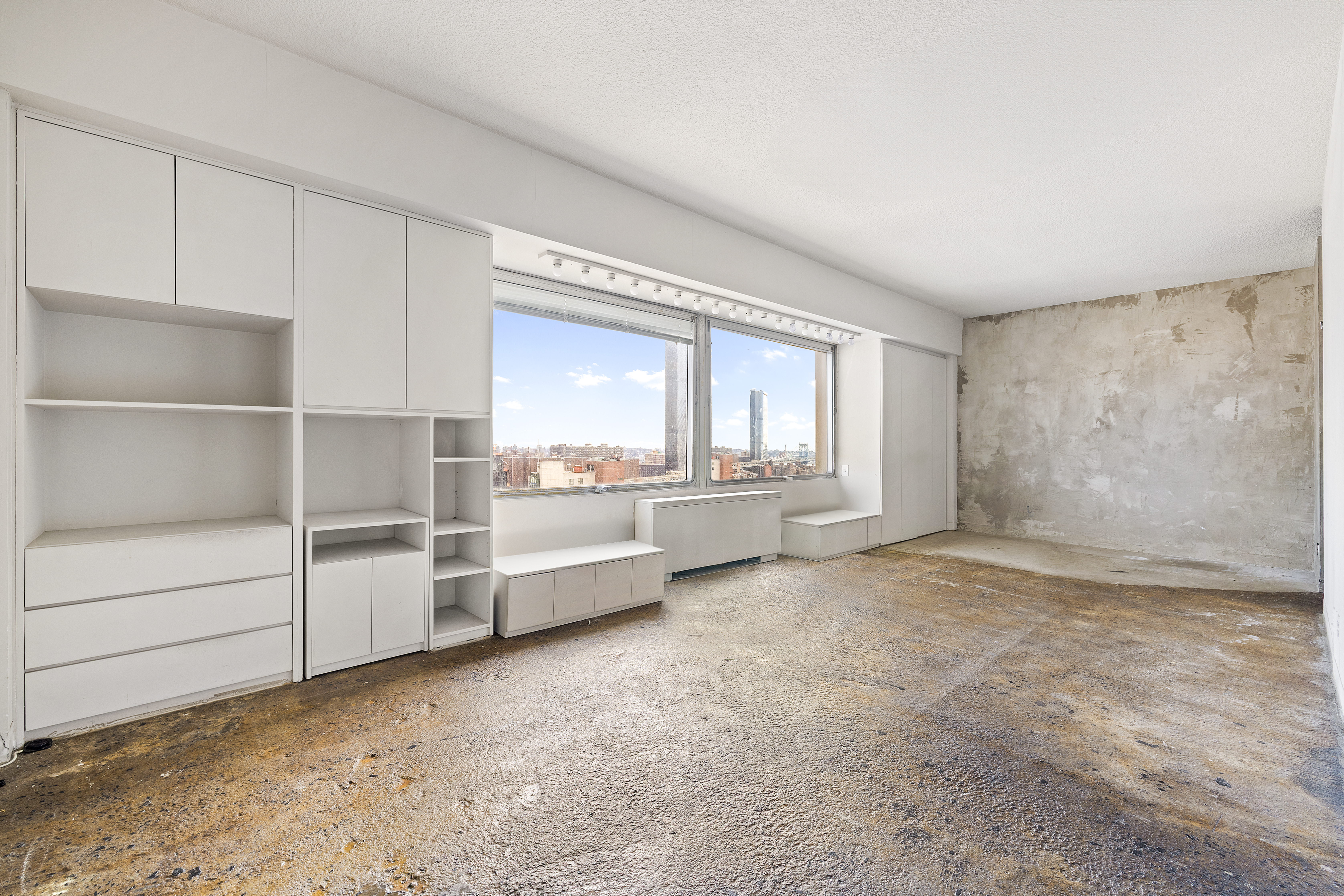 180 Park Row, Unit 25E Manhattan, NY 10007 - Photo 2 of 11 a view of a room with cabinet and mirrors