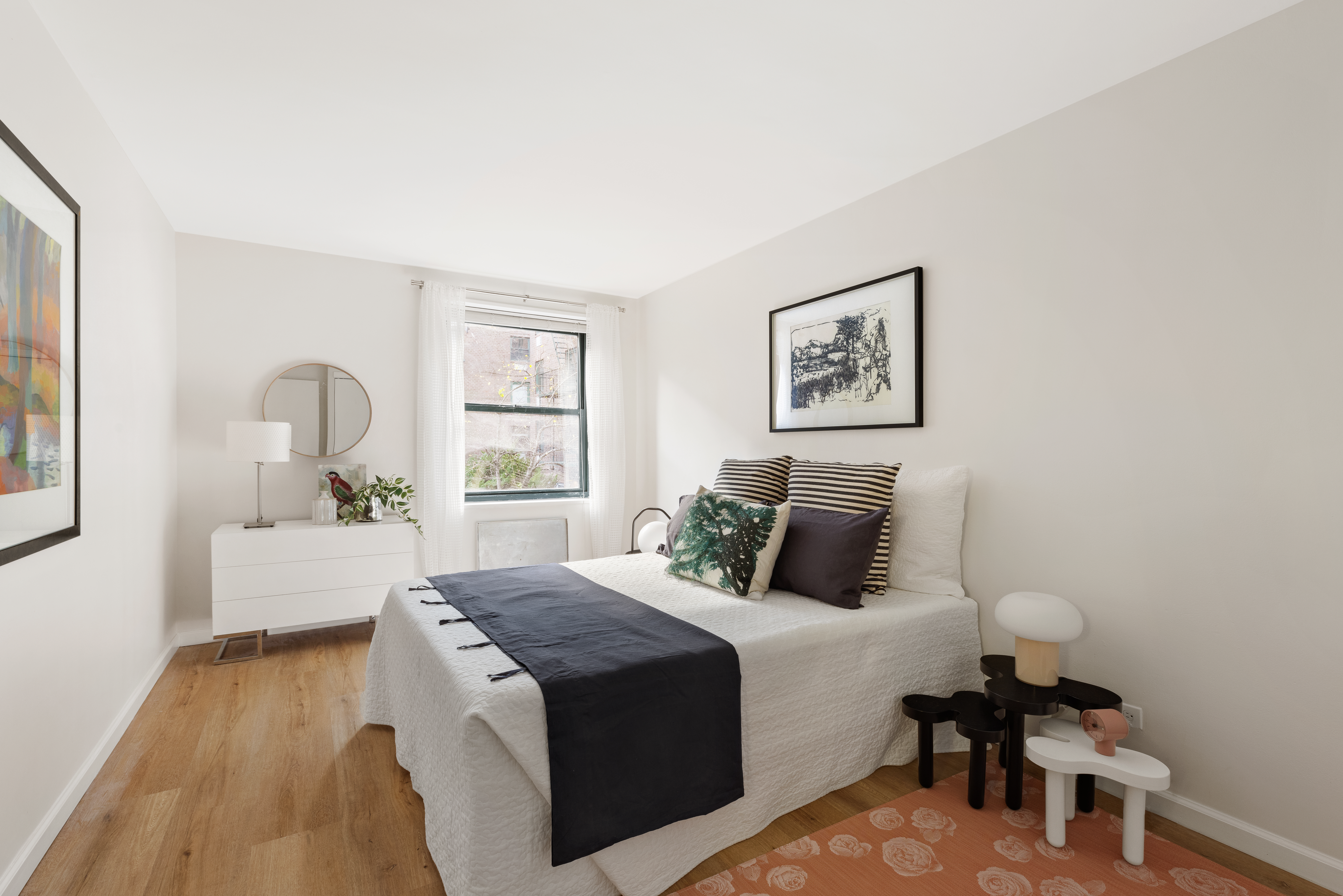 141 Barrow Street, Unit 1B Manhattan, NY 10014 - Photo 4 of 10 a bedroom with a large bed and a window