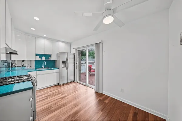an open kitchen with wooden floor and window