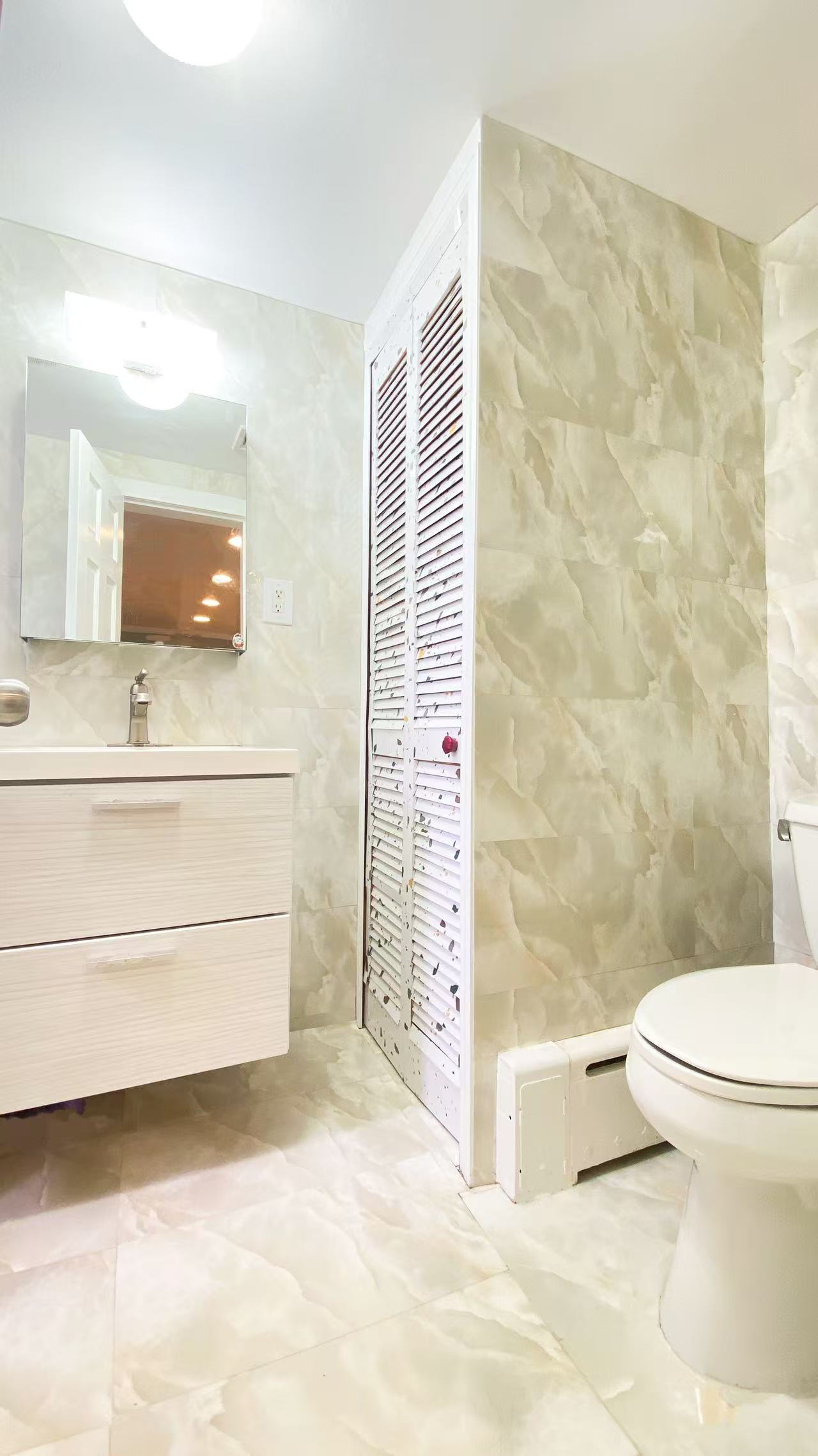 10-12 Church Street Queens, NY 11414 - Photo 7 of 16 a bathroom with a sink toilet and shower