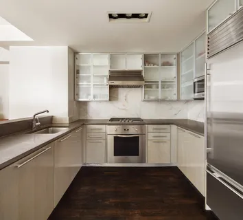 a kitchen with a sink stainless steel appliances and cabinets