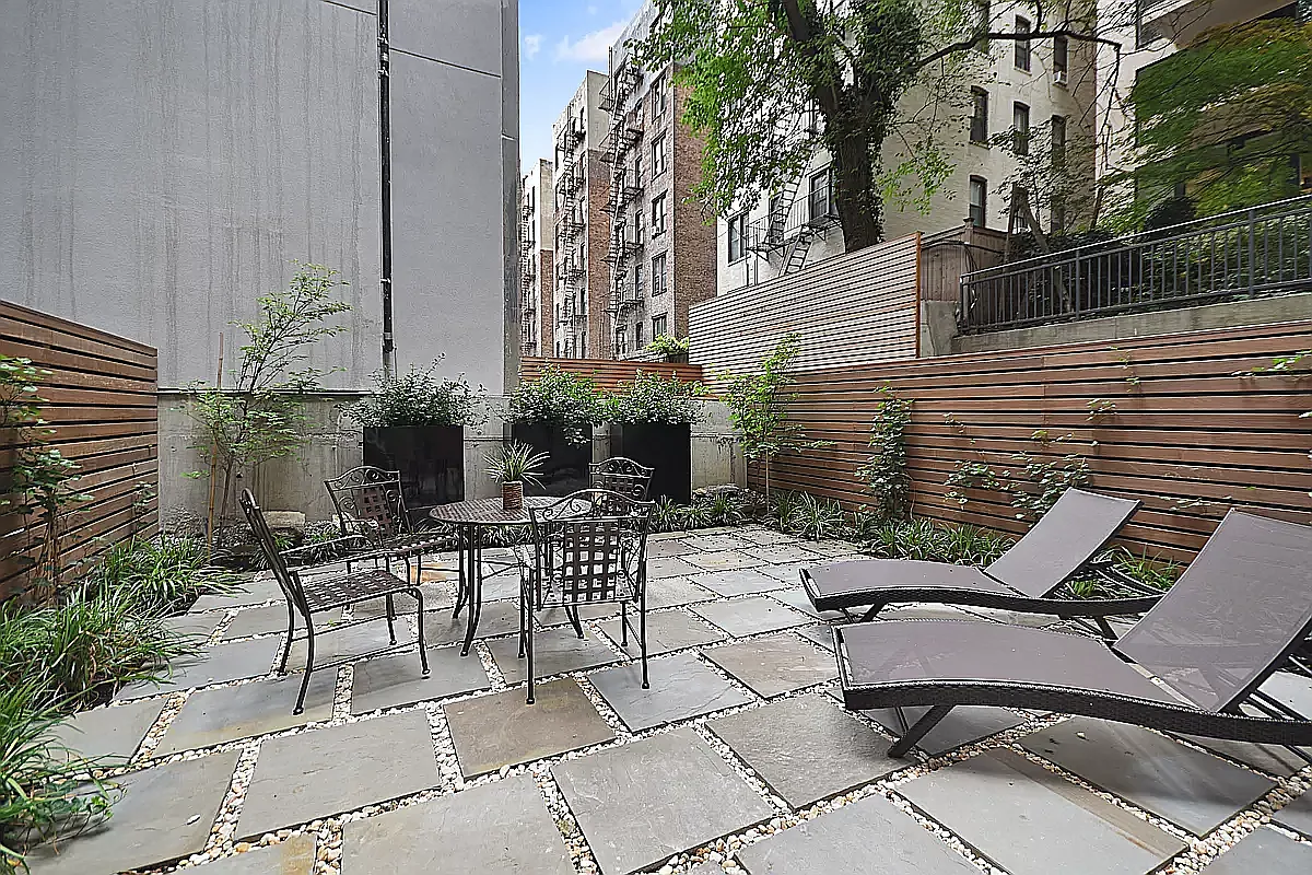 a view of a patio with couple of chairs