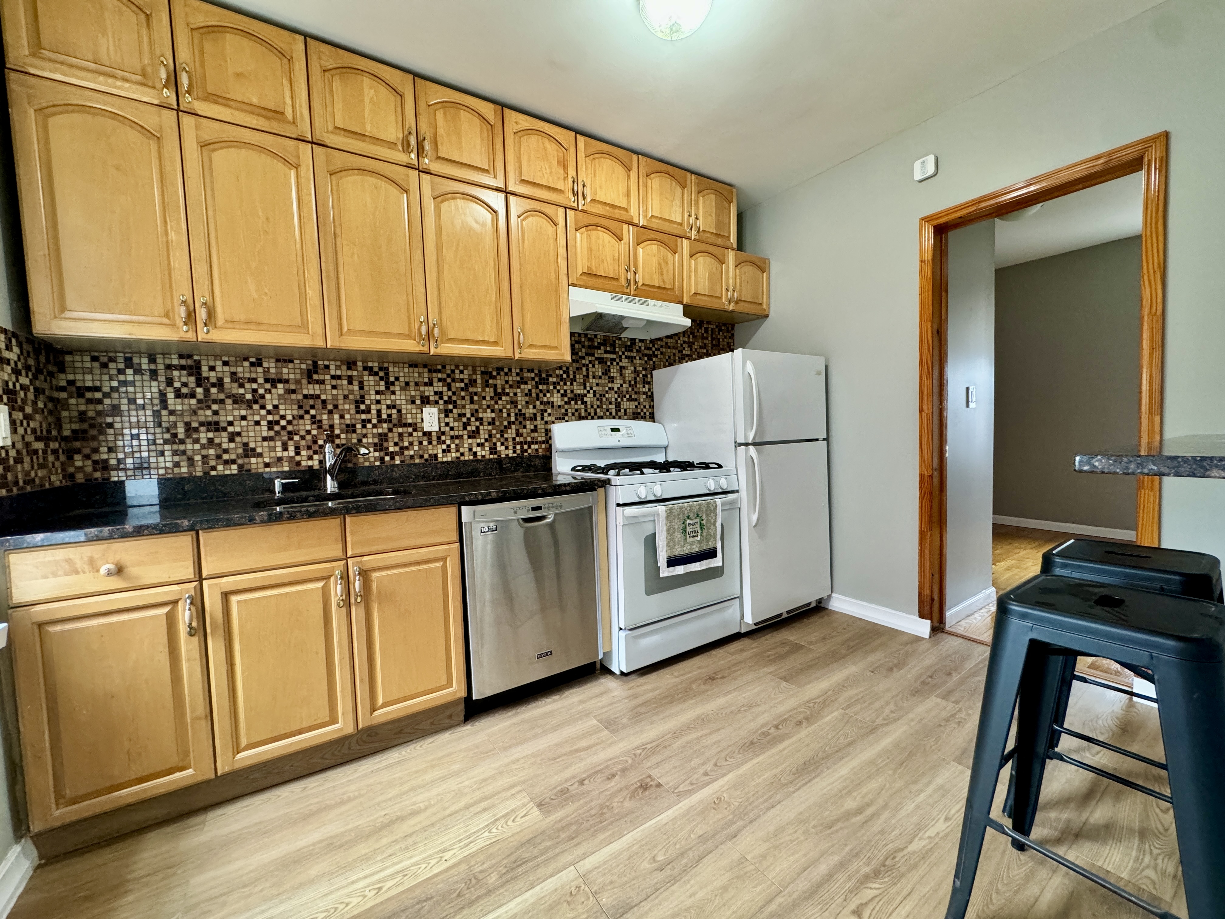 133 17th Street, Unit 4R Brooklyn, NY 11215 - Photo 3 of 7 a kitchen with stainless steel appliances granite countertop a stove a sink dishwasher and a refrigerator with wooden floor
