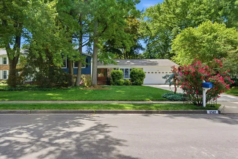 a front view of a house with a garden