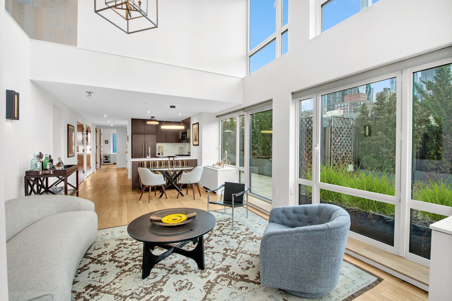 454 West 54th Street, Unit PHC Manhattan, NY 10019 - Photo 3 of 27 a living room with furniture and a table with garden view