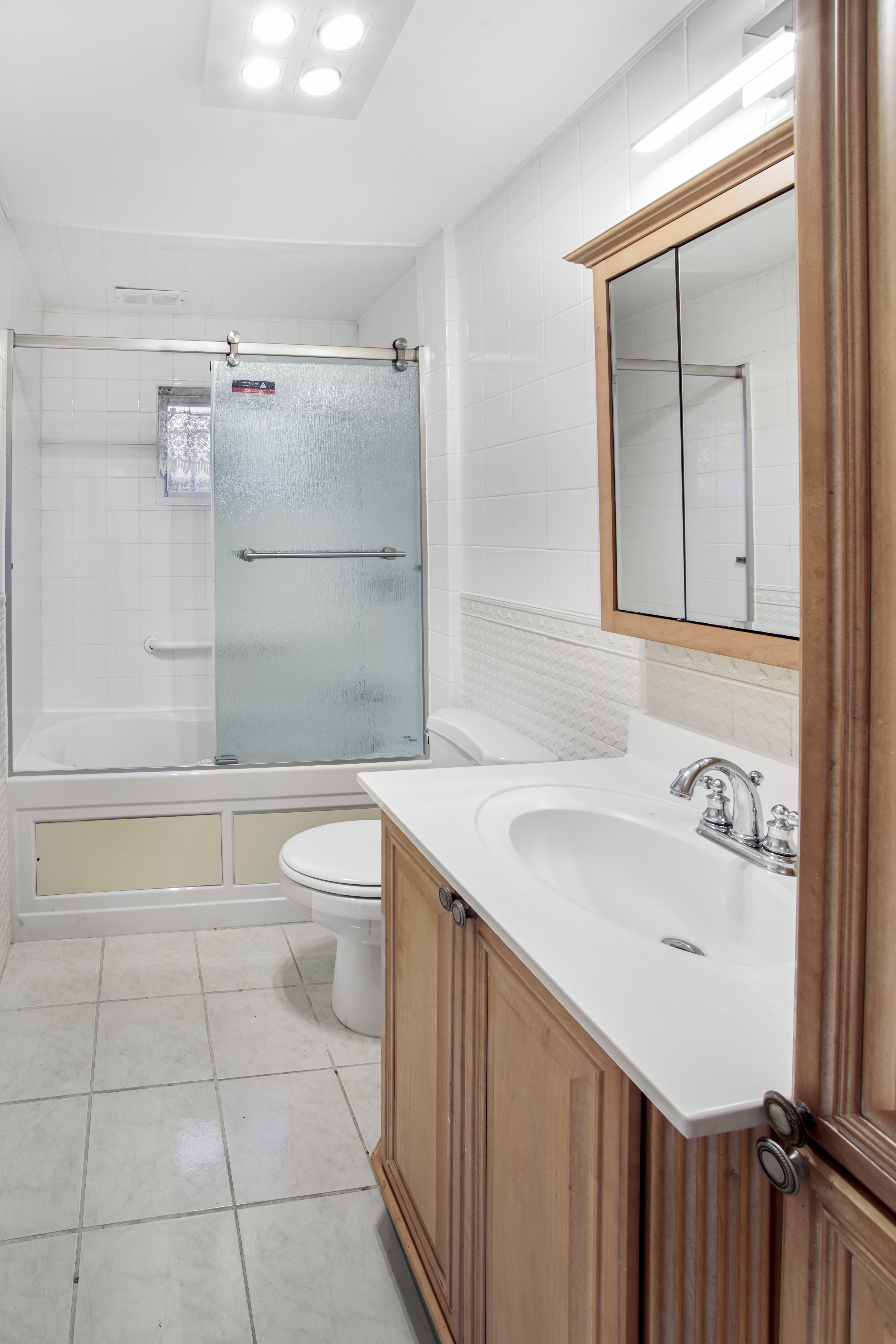 60 82nd Street Brooklyn, NY 11209 - Photo 17 of 19 a bathroom with a sink a toilet and shower