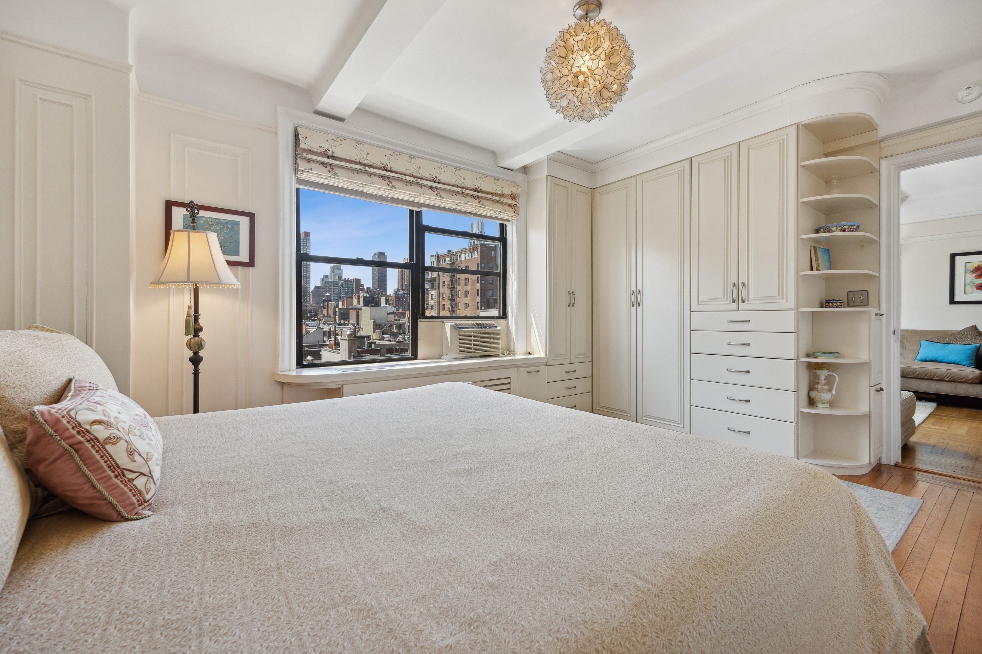 40 West 77th Street, Unit 8C Manhattan, NY 10024 - Photo 11 of 21 a bedroom with a bed and a chandelier