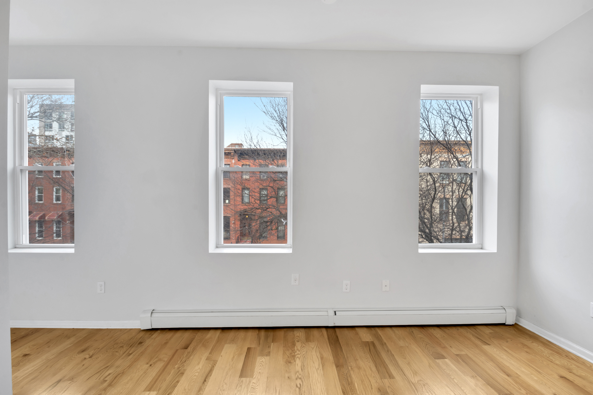 184 Herkimer Street, Unit 2 Brooklyn, NY 11216 - Photo 2 of 9 a view of an empty room with wooden floor and a window