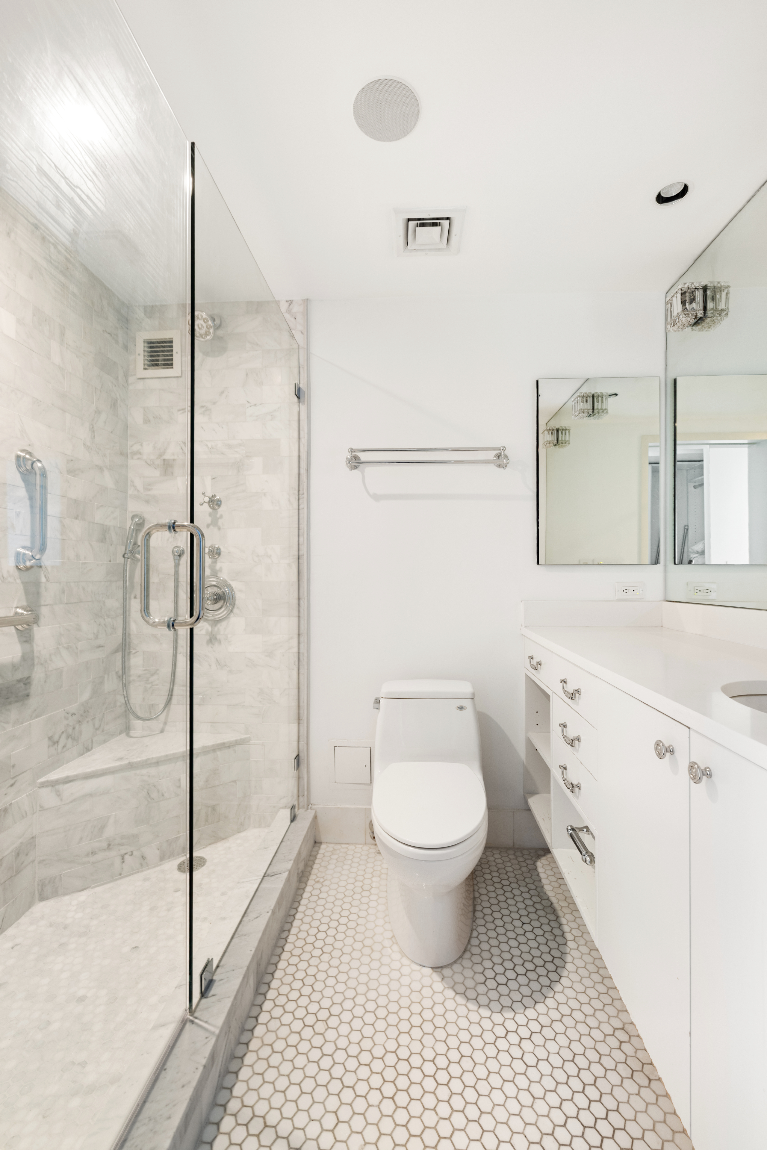 188 East 70th Street, Unit 22A Manhattan, NY 10021 - Photo 11 of 17 a bathroom with a toilet a sink and a shower