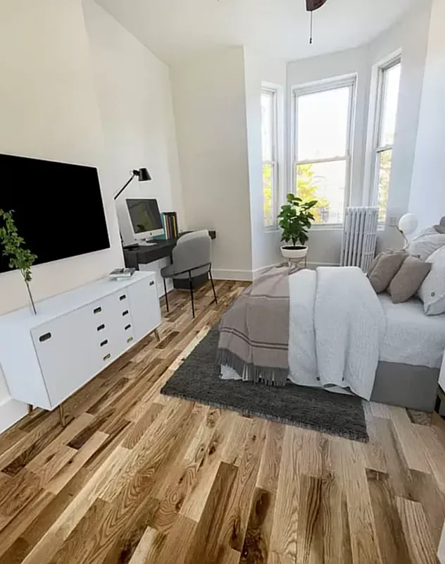 1128 Bushwick Avenue, Unit A Brooklyn, NY 11221 - Photo 8 of 14 a bedroom with a bed and a flat screen tv