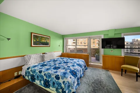 a bedroom with a bed and a couch