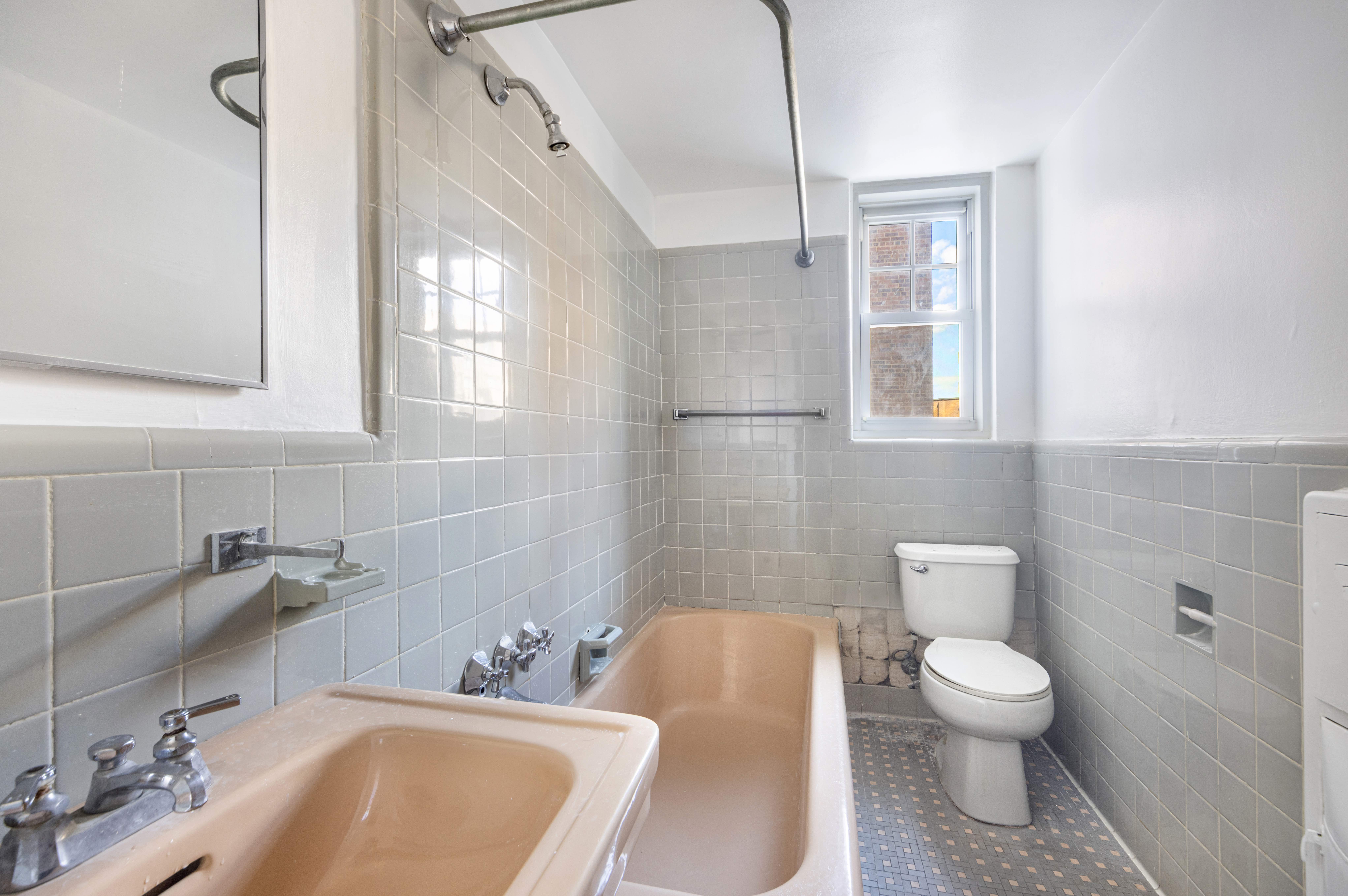 200 Cabrini Boulevard, Unit 17 Manhattan, NY 10033 - Photo 10 of 24 a bathroom with a toilet sink and mirror