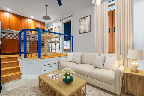a living room with furniture a ceiling fan and a window