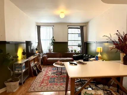 a living room with furniture a window and a fireplace