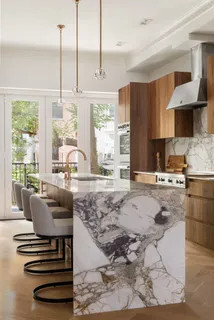 a kitchen with stainless steel appliances granite countertop a stove a sink and a refrigerator