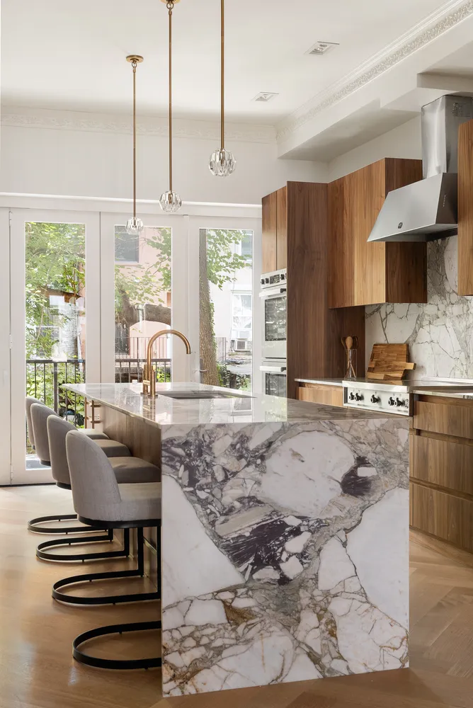 a kitchen with stainless steel appliances granite countertop a stove a sink and a refrigerator