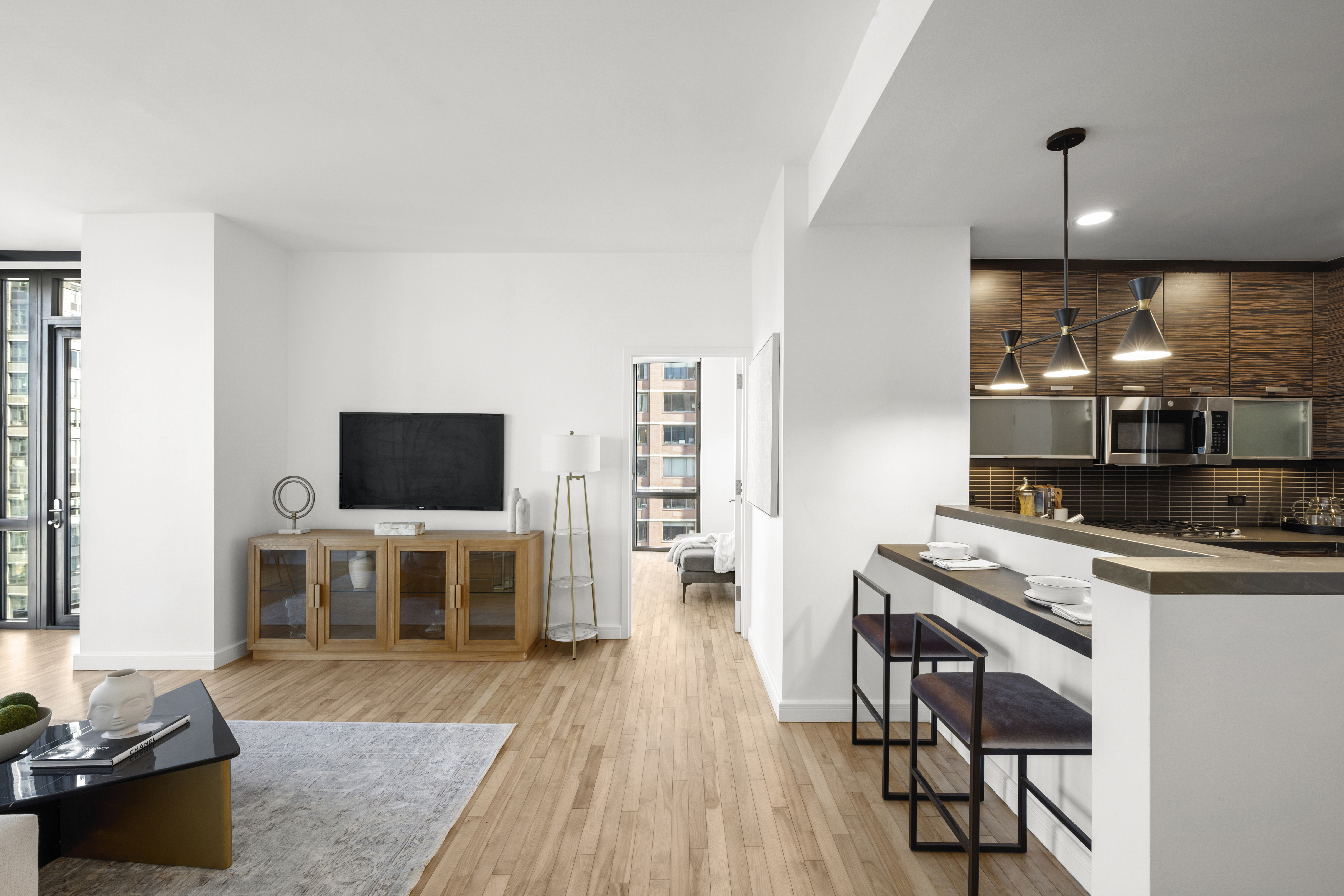 101 West 24th Street, Unit 23E Manhattan, NY 10011 - Photo 8 of 23 a living room with furniture and a flat screen tv