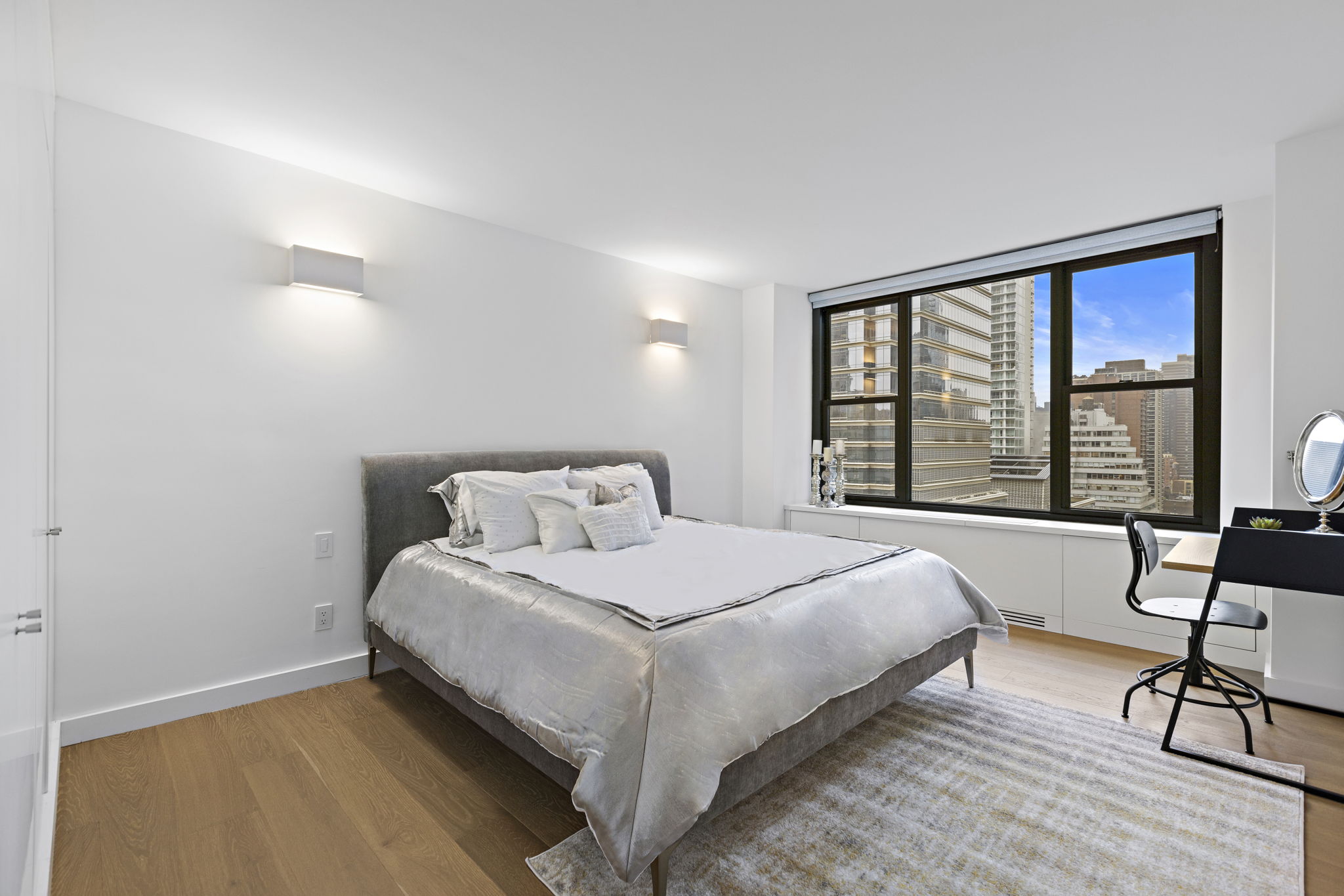 117 East 57th Street, Unit 21H Manhattan, NY 10022 - Photo 13 of 26 a bedroom with a bed and a table