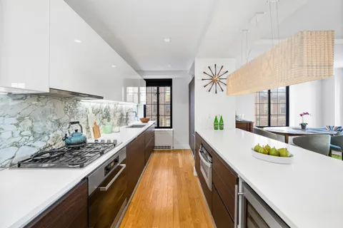 a large kitchen with sink and stainless steel appliances
