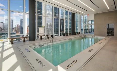 a large swimming pool with a large window and outside view