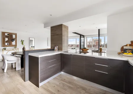 a kitchen with stainless steel appliances kitchen island granite countertop a sink counter space and wooden floor