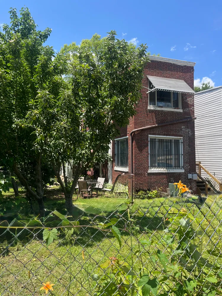 a backyard of a house with table and chairs
