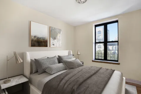 a bedroom with a bed and a window