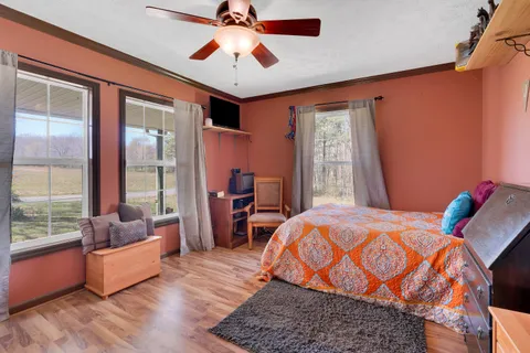 a bedroom with furniture and a large window