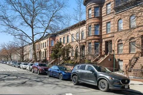 a view of a cars park in front of a building