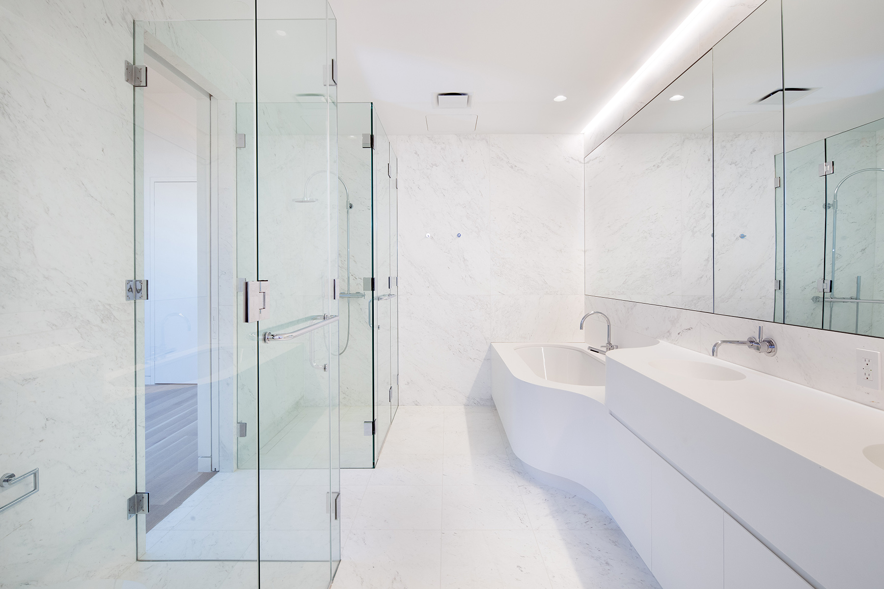 67-69 Franklin Street, Unit 2B Manhattan, NY 10013 - Photo 5 of 16 a bathroom with a double vanity sink a large mirror and shower