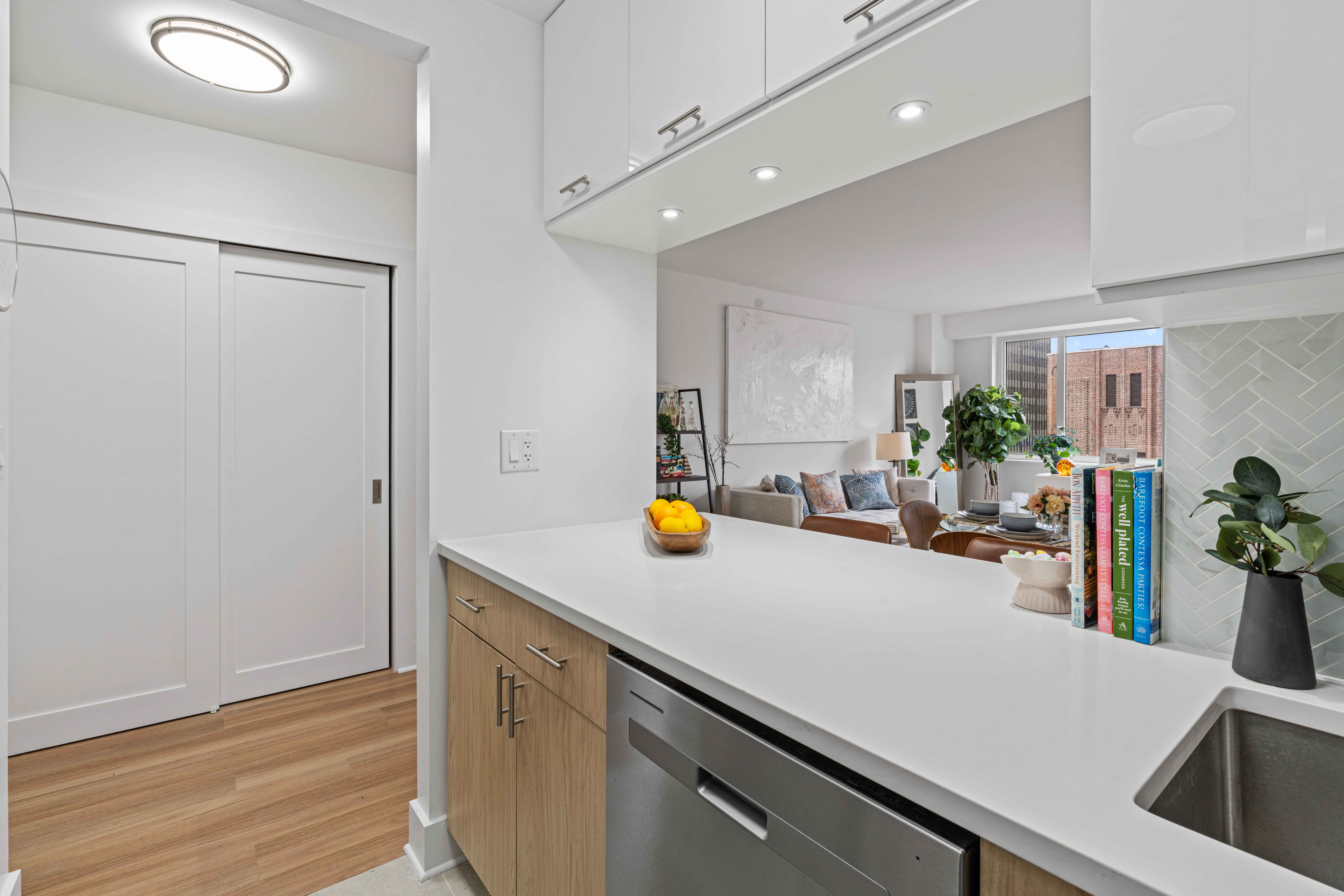 400 East 54th Street, Unit 22D Manhattan, NY 10022 - Photo 5 of 21 a kitchen with a sink and wooden floor