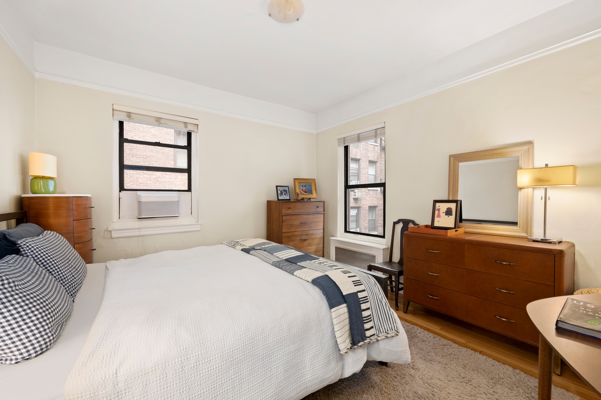 62 East 87th Street, Unit 3C Manhattan, NY 10128 - Photo 4 of 7 a bedroom with a bed and wooden floor